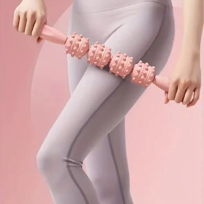 femme debout roule rouleau de massage rose sur cuisse