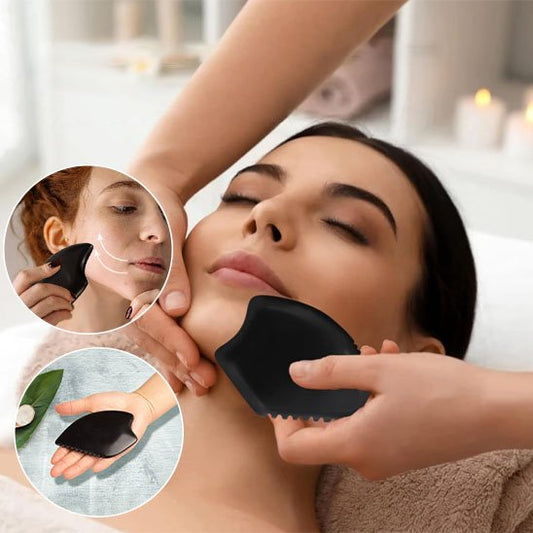 main sur pierre gua sha sur le visage dans un salle de massage
