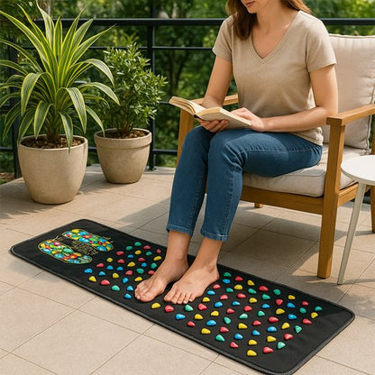 femme avec un livre sur tapis d'acupression sur le balcon